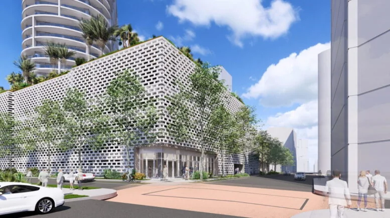 Render del acceso peatonal junto al podio ajardinado de 464 Fern Street, con la torre visible arriba y edificios del downtown al fondo
