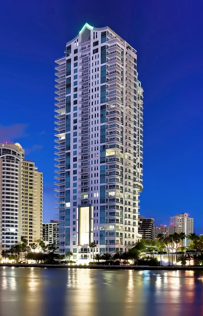 Torre de condominios Asia Brickell Key iluminada de noche en Brickell Key, Miami