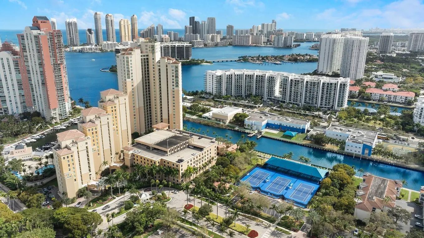 Aerial view of Aventura Marina's towers, marina, and tennis courts in Aventura, Florida