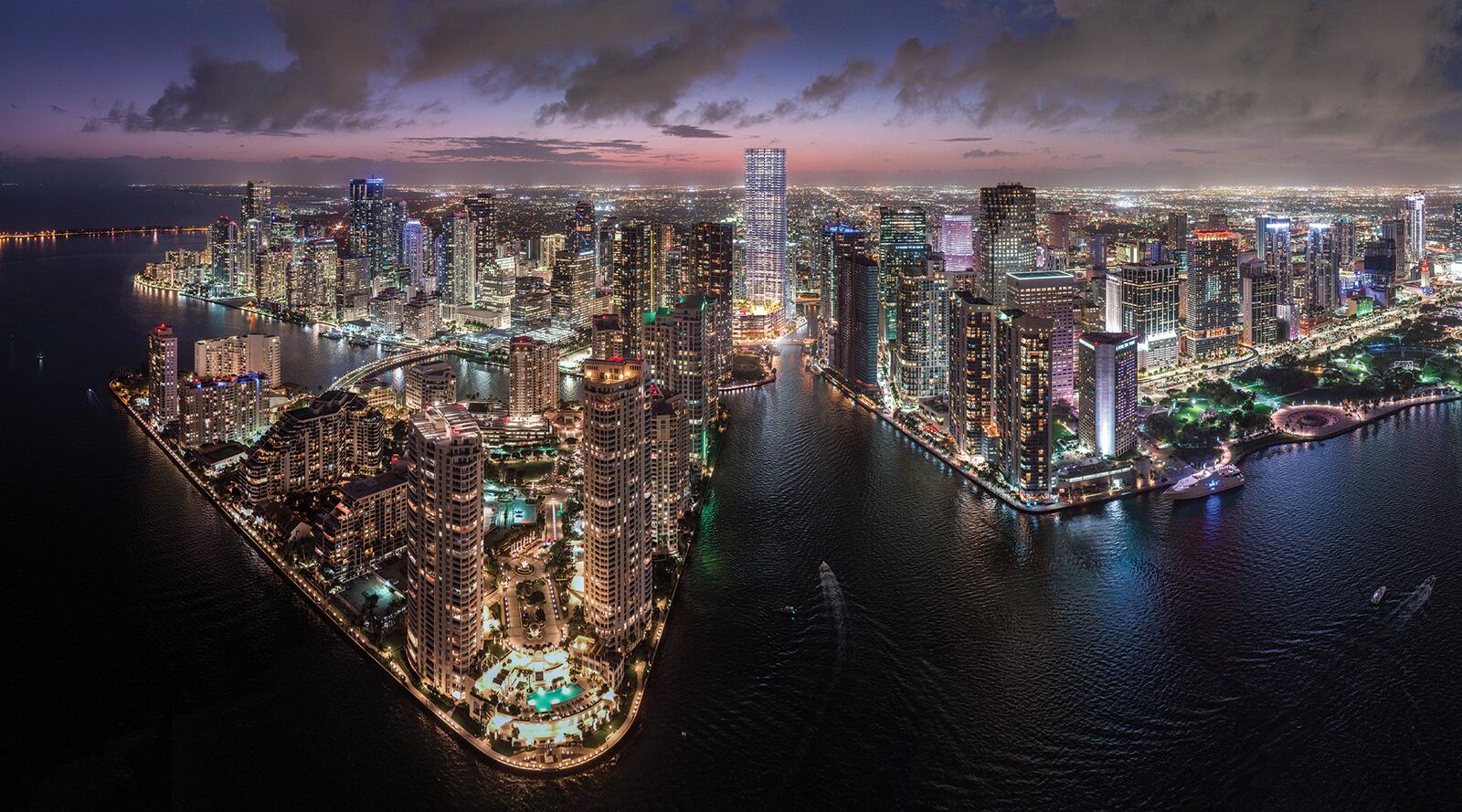 Baccarat Residences Miami glowing over the Miami River and Brickell skyline at night