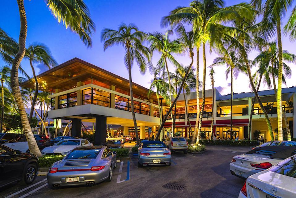 Bal Harbour Shops at dusk, the open-air luxury shopping destination in Bal Harbour, Florida, framed by palm trees and lit storefronts