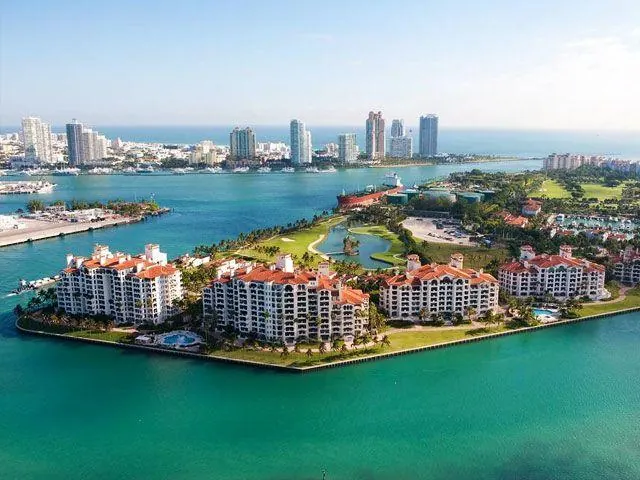 Bayview condominium residences on Fisher Island, waterfront with Miami skyline beyond