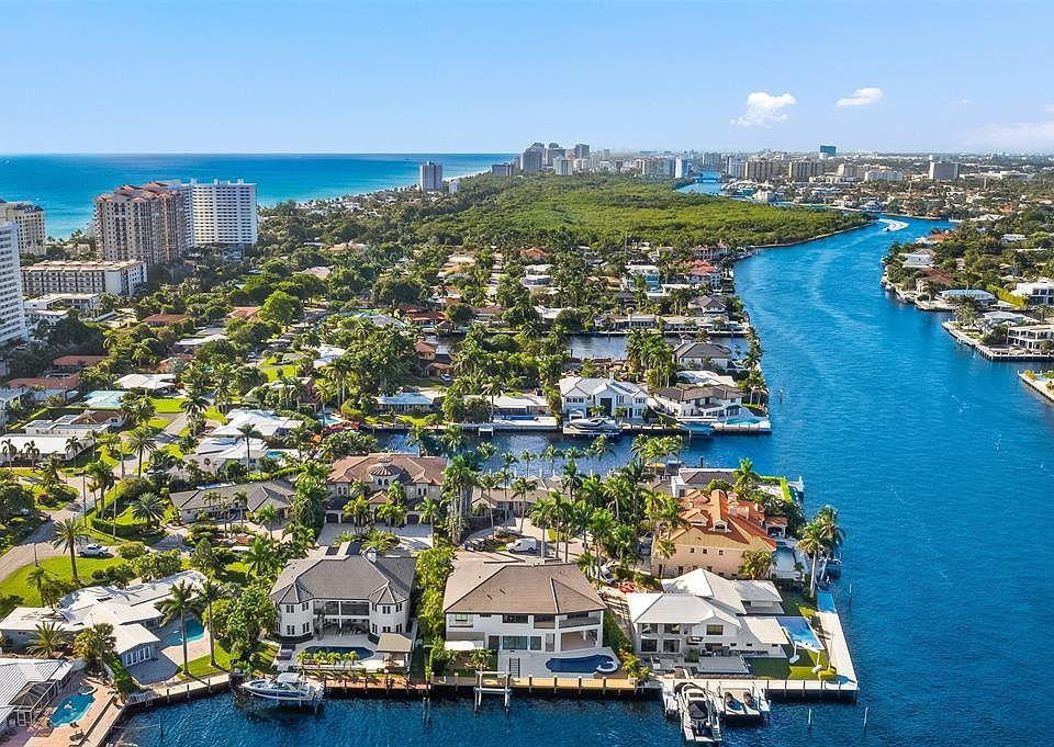 Aerial view of luxury Fort Lauderdale waterfront estates with private docks and yachts lining an Intracoastal canal