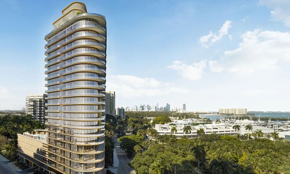 Torre curva frente a la bah&iacute;a de Four Seasons Private Residences Coconut Grove sobre la marina con el skyline de Miami al fondo