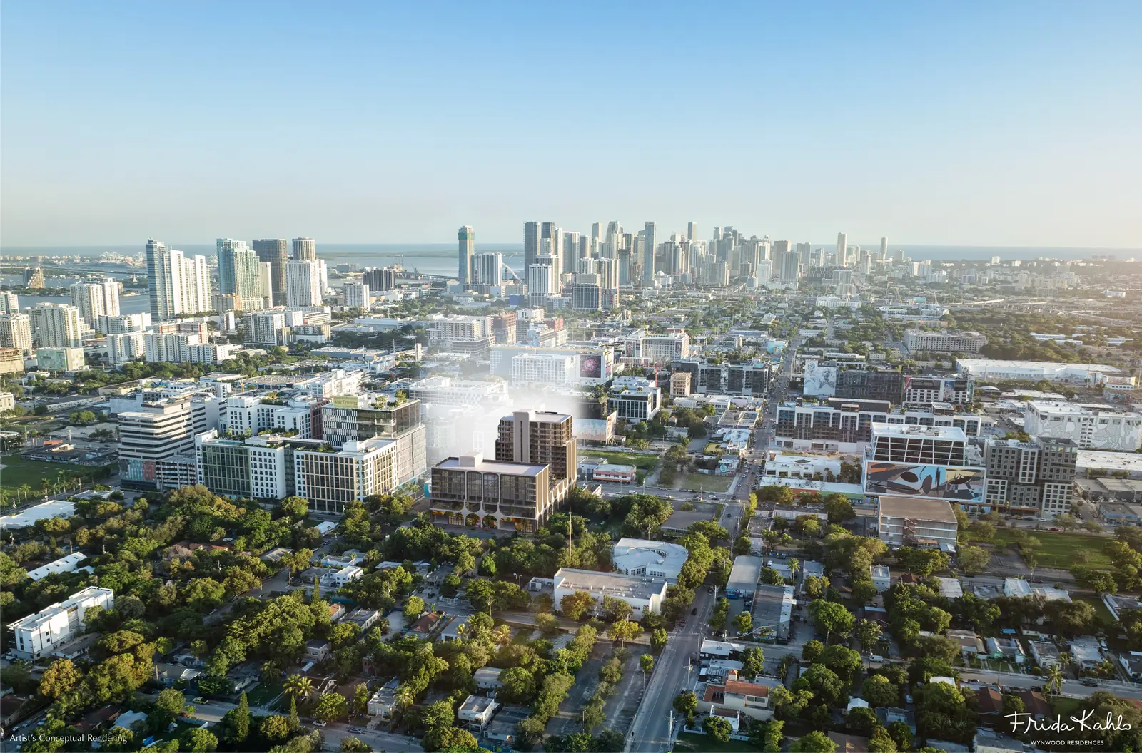 Artist's conceptual aerial rendering of Frida Kahlo Wynwood Residences within the Wynwood district, with the Downtown Miami and Brickell skylines and Biscayne Bay beyond