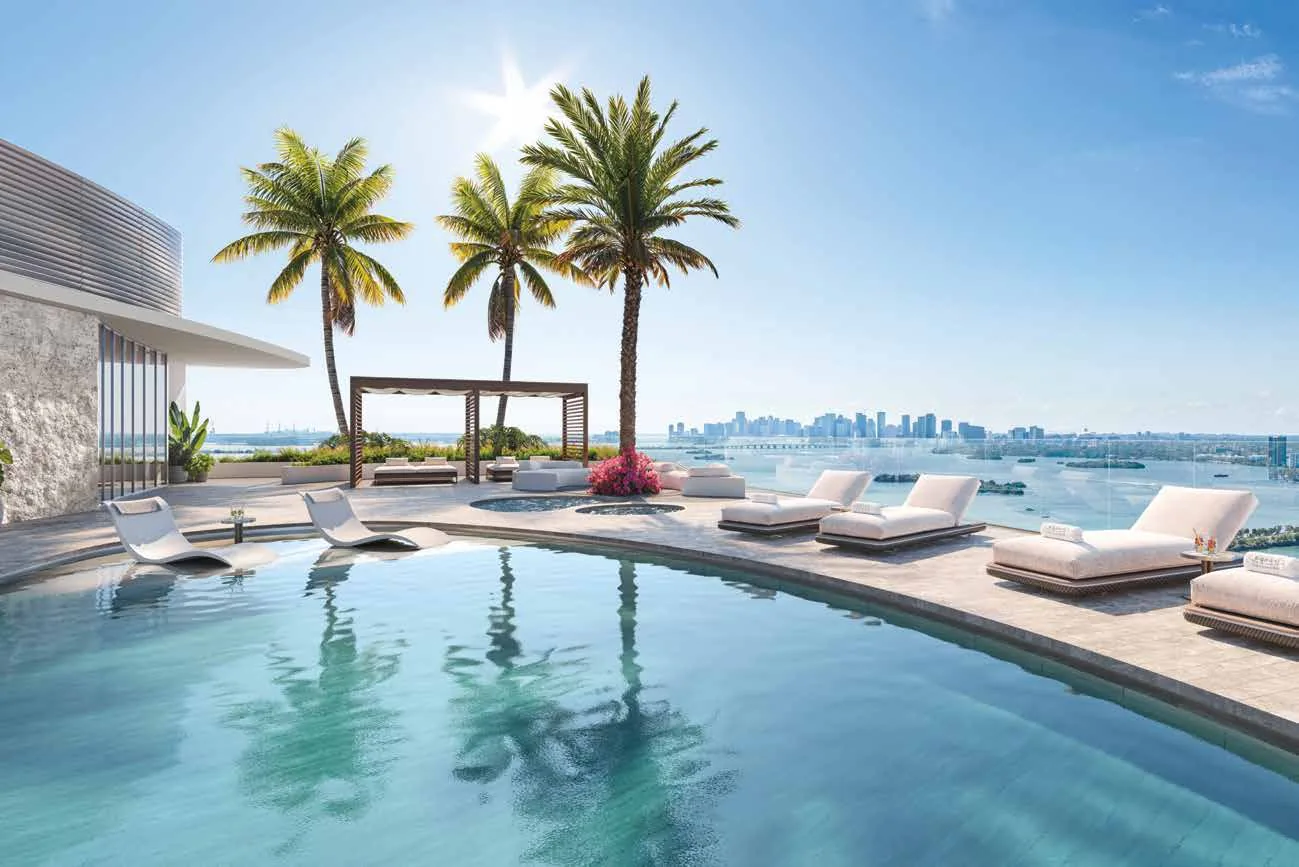 Representación conceptual del artista de la piscina y el Sky Lounge en la azotea de Pagani Residences, con cabanas, palmeras y vistas de 360 grados sobre Biscayne Bay hacia el perfil de Miami