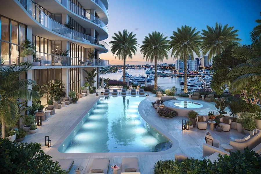 Marina-view pool deck and spa at The St. Regis Residences, Bahia Mar illuminated at dusk (artist's conceptual rendering)