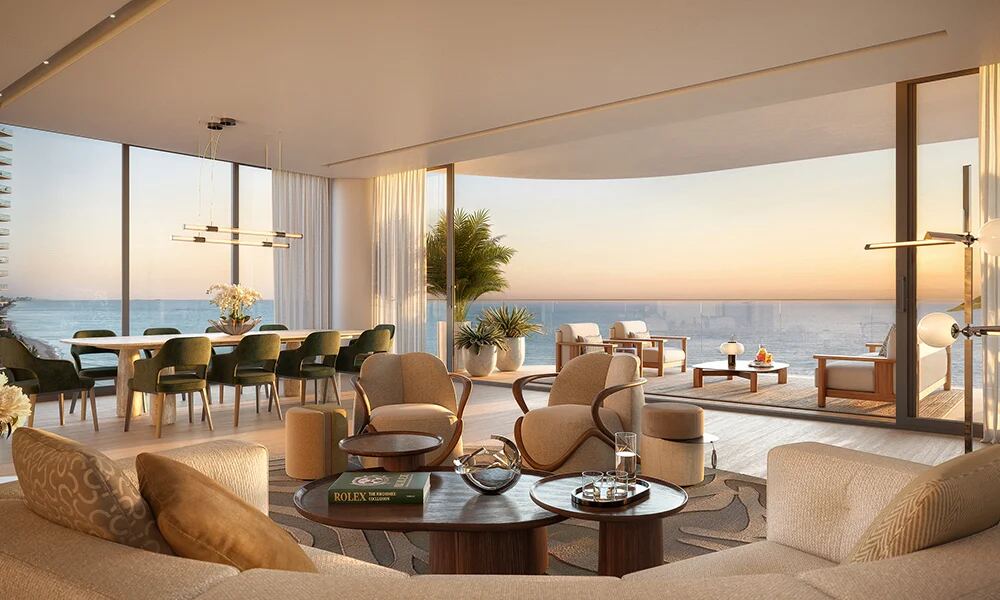 Light-filled residence living room with floor-to-ceiling glass framing sunrise ocean views at The St. Regis Residences Sunny Isles Beach