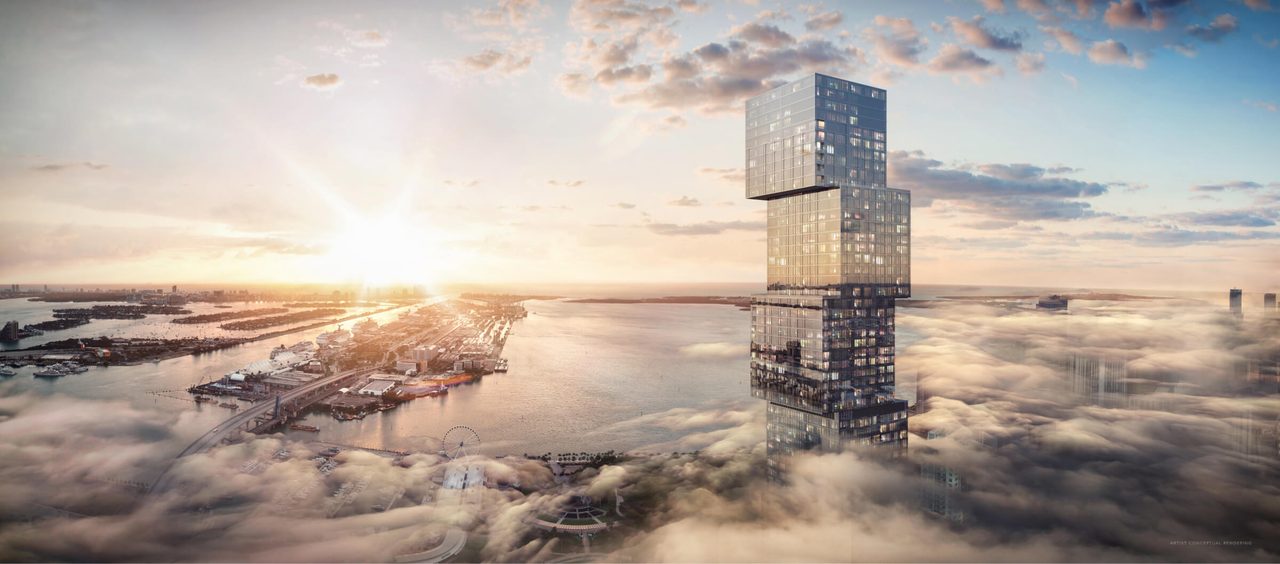 Exterior rendering of the Waldorf Astoria Residences Miami supertall tower rising above the clouds over Biscayne Bay at sunset